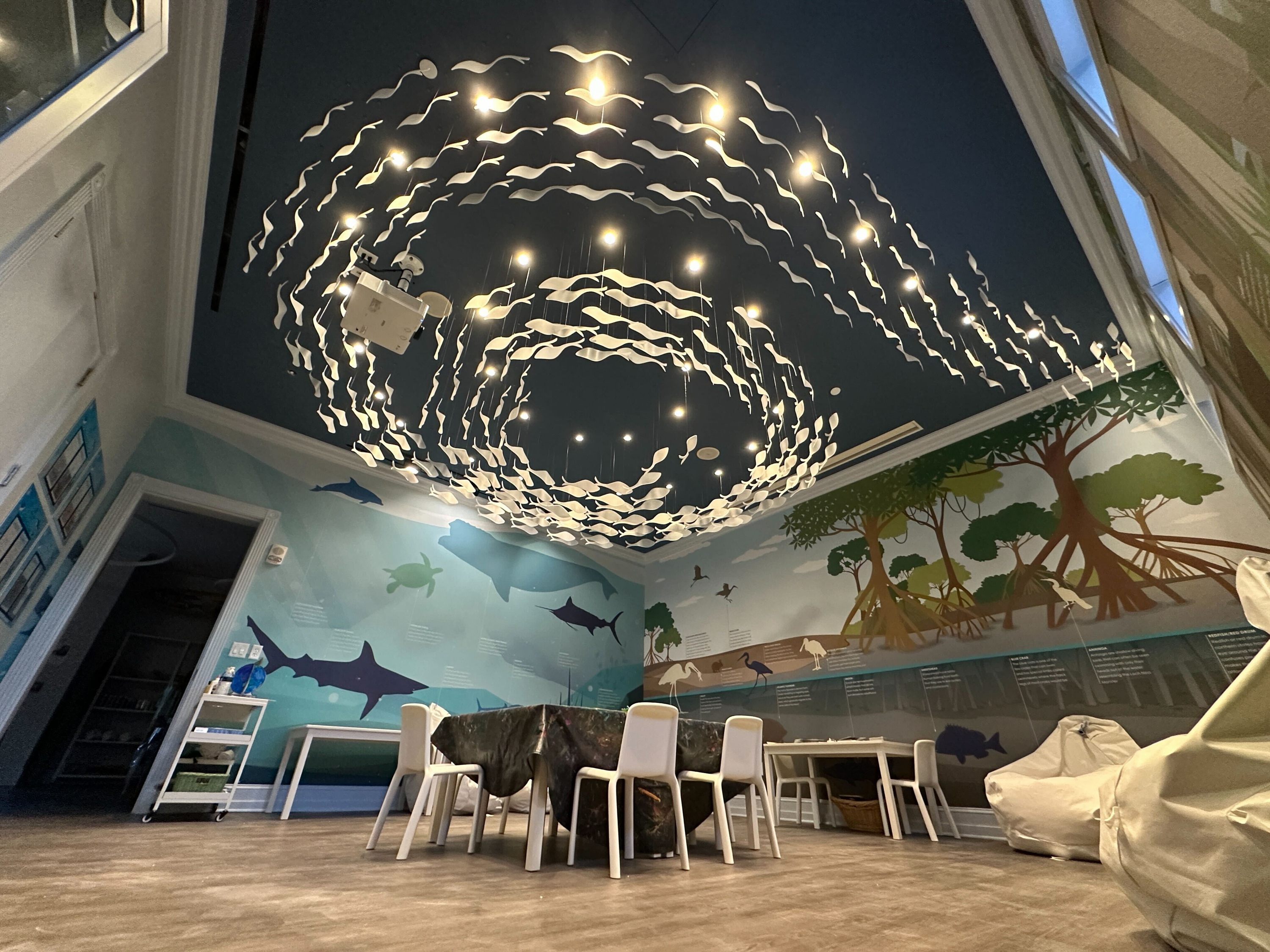 Angled ceiling detail — swirling fish installation