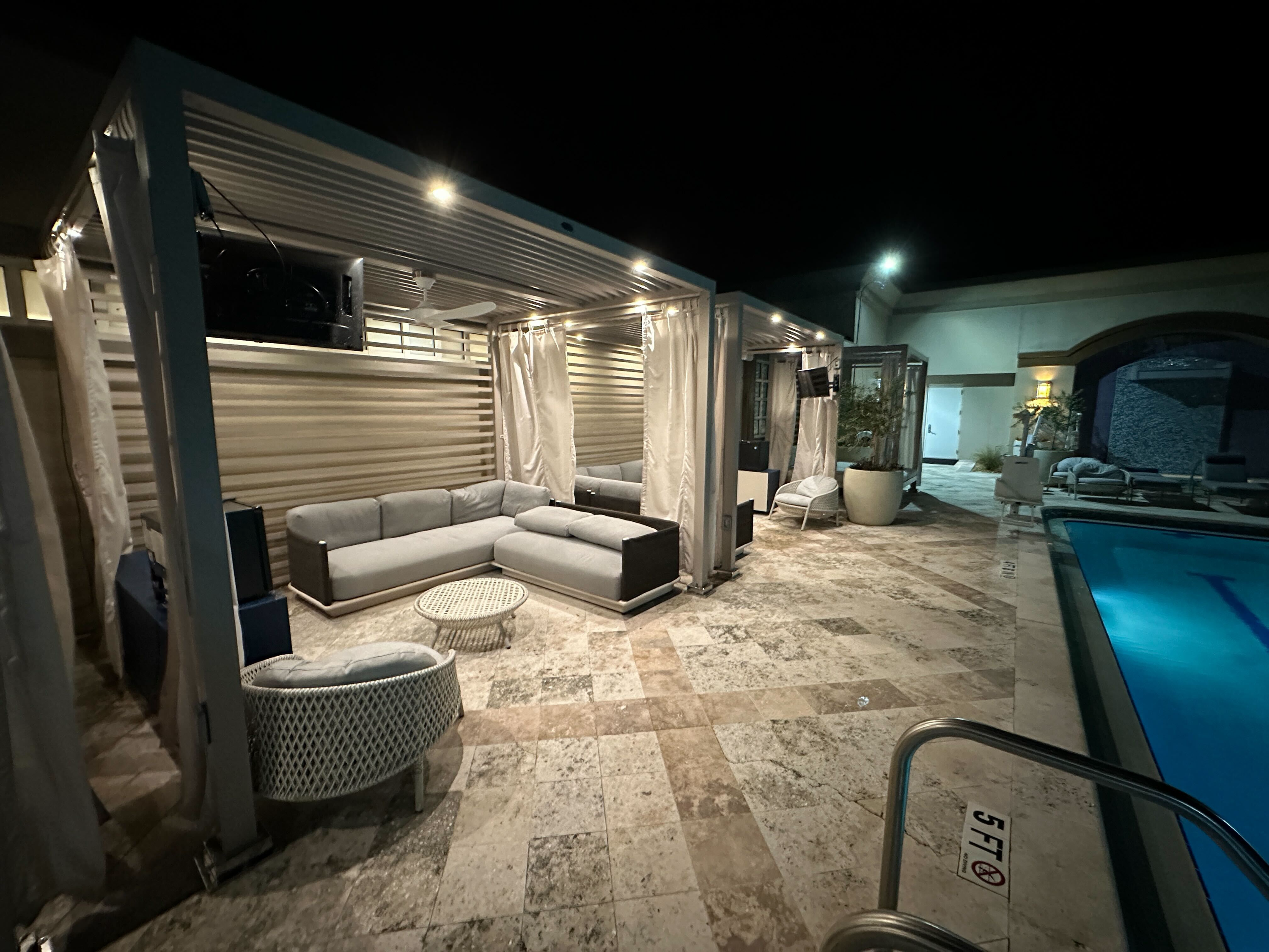 Poolside cabana — edge view with pool in foreground