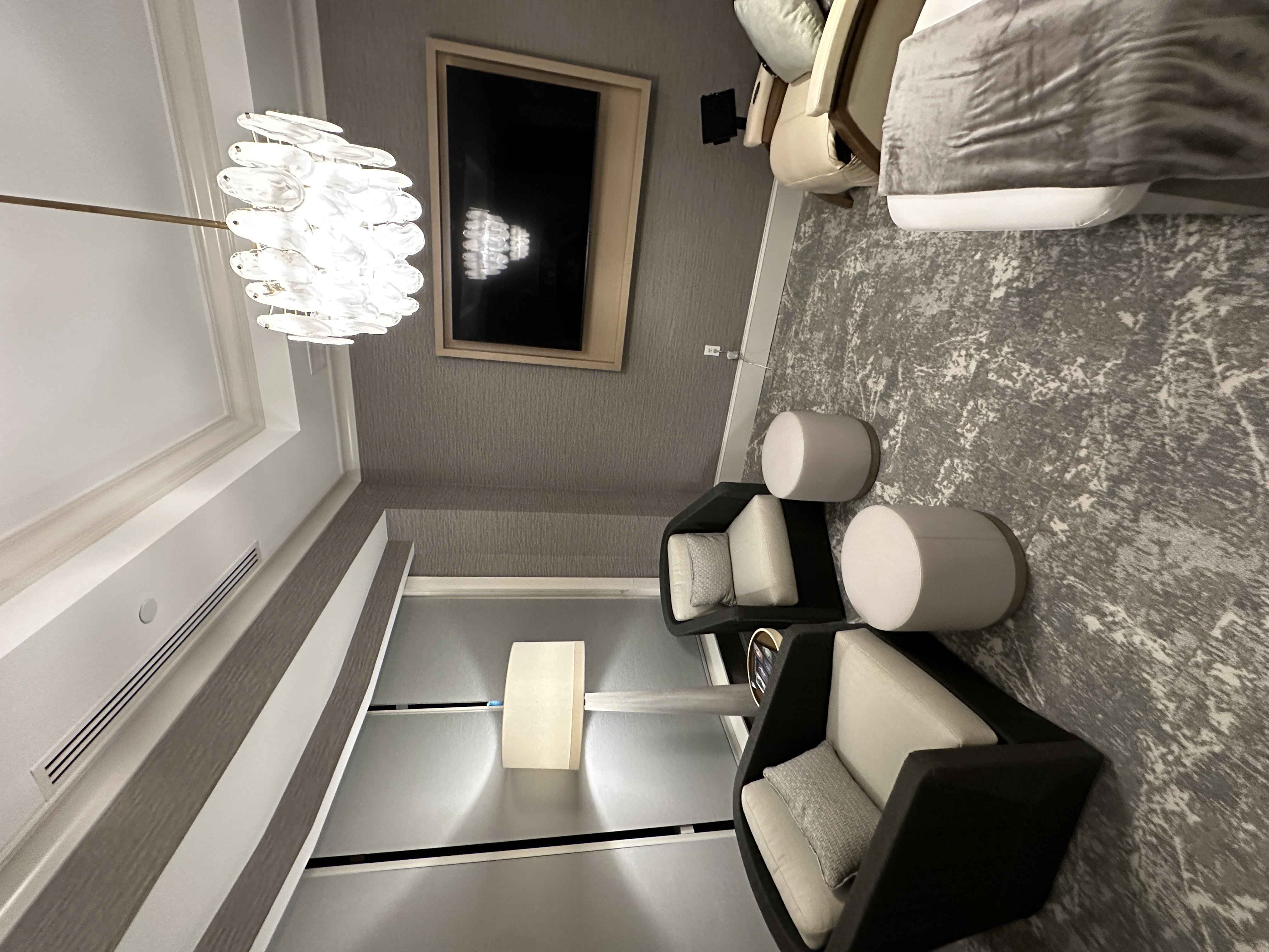 Treatment suite with crystal chandelier and dark armchairs