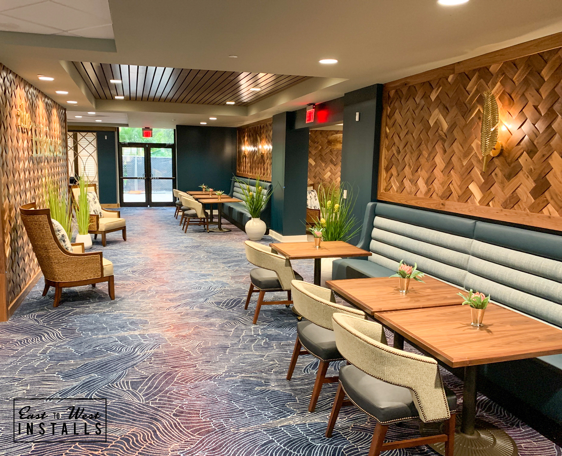 Dining corridor with herringbone wood panels and patterned carpet